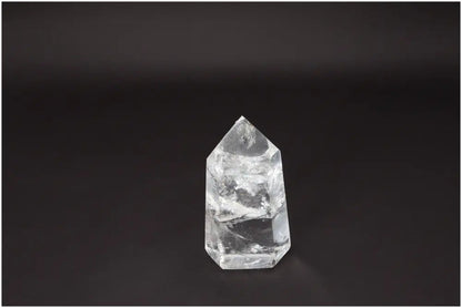 Lemurian Quartz Obelisk on dark background, showcasing its natural clarity and beauty for crystal healing and energy amplification.