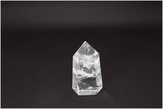 Lemurian Quartz Obelisk on dark background, showcasing its natural clarity and beauty for crystal healing and energy amplification.