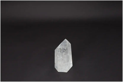 Lemurian Quartz Obelisk on a dark background, known for clarity, balance, and growth. Ethically sourced, master healer crystal product.