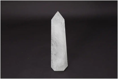 Lemurian Quartz Obelisk against dark background, clear quartz known as the Master Healer for energy amplification and personal growth.