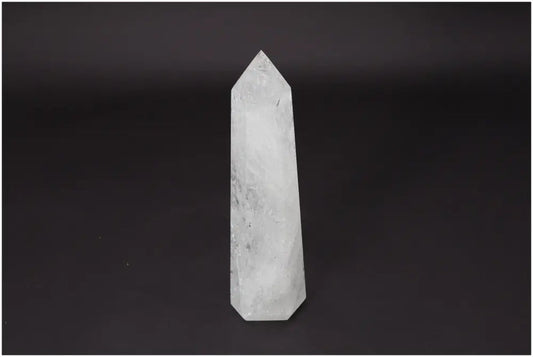 Lemurian Quartz Obelisk against dark background, clear quartz known as the Master Healer for energy amplification and personal growth.