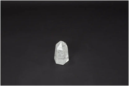 Lemurian Quartz Obelisk against dark background; Clear Quartz for clarity and balance; Master Healer crystal; ethically sourced.