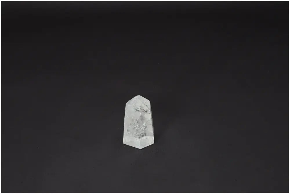 Lemurian Quartz Obelisk crystal on a dark background, known for clarity and energy amplification, ethically sourced and naturally formed.