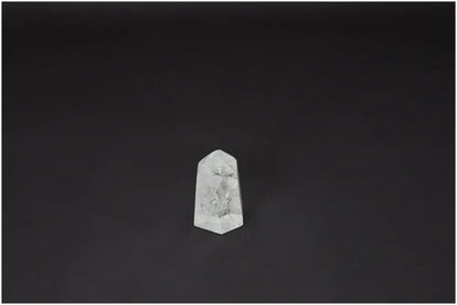 Lemurian Quartz Obelisk crystal on a dark background, known for clarity and energy amplification, ethically sourced and naturally formed.