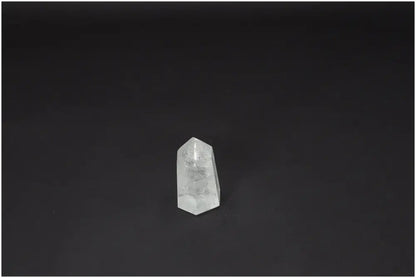 Lemurian Quartz Obelisk on dark background, showcasing its clarity and natural beauty as a Master Healer crystal for personal growth.
