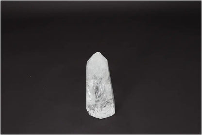 Clear Lemurian Quartz Obelisk on black background, known for enhancing clarity, balance, and personal growth. Ethically sourced crystal.