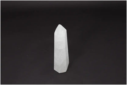 Lemurian Quartz Obelisk on dark background, clear crystal known as the 'Master Healer' for clarity and personal growth.
