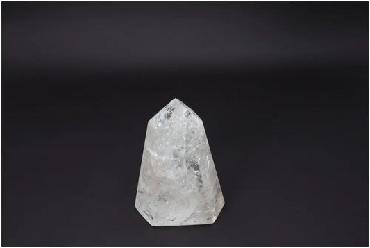 Lemurian Quartz Obelisk: Clear quartz crystal on dark background symbolizing clarity, balance, and personal growth.