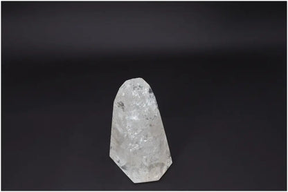 Lemurian Quartz Obelisk against a dark background, showcasing its natural clarity and crystalline structure.