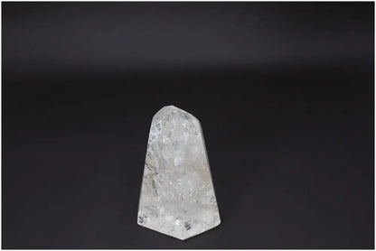 Lemurian Quartz Obelisk displaying clear crystalline structure for clarity, balance, and personal growth on a dark background.