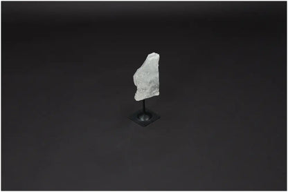Lemurian Quartz on metal stand against dark background, highlighting crystal clarity and elegance for personal growth and balance.