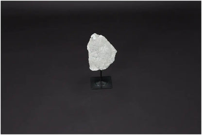 Lemurian Quartz crystal on a sleek metal stand, highlighting its natural clarity and elegance against a dark backdrop.