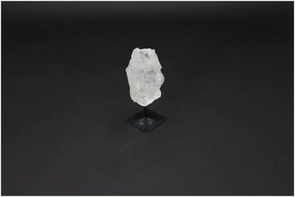 Lemurian Quartz crystal on a metal stand against a dark background, showcasing its natural clarity and healing properties.