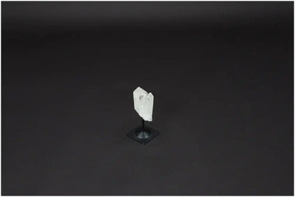 Lemurian Quartz crystal on a sleek metal stand against a dark background, showcasing its natural clarity and healing properties.