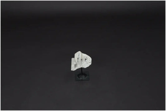 Lemurian Clear Quartz crystal on a black metal stand, symbolizing clarity, balance, and personal growth, known as the Master Healer.