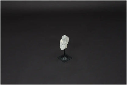 Lemurian Quartz Crystal on a metal stand against a dark background, symbolizing clarity and balance in personal growth.