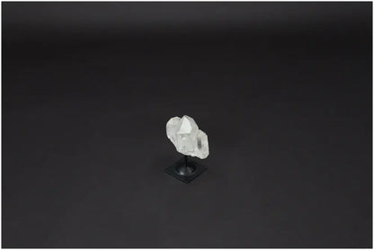 Lemurian Quartz on a stylish metal stand against a dark background, ideal for energy amplification and personal growth.