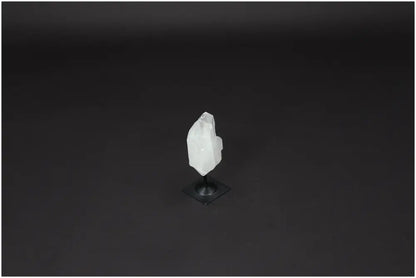 Lemurian Quartz crystal on a metal stand, symbolizing clarity and healing, against a dark background.