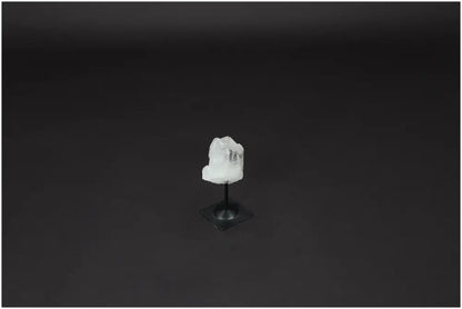 Lemurian Quartz crystal on a metal stand against a dark background, highlighting its clarity and elegance.