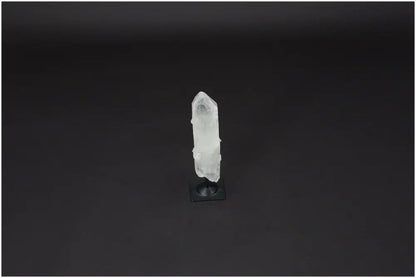 Lemurian Quartz crystal on metal stand against black background, promoting clarity and balance as a powerful "Master Healer."