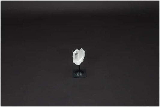 Lemurian Quartz on metal stand against dark background, showcasing its natural clarity and healing properties.