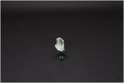 Lemurian Quartz on elegant metal stand against dark background, showcasing its natural beauty and clarity-enhancing properties.