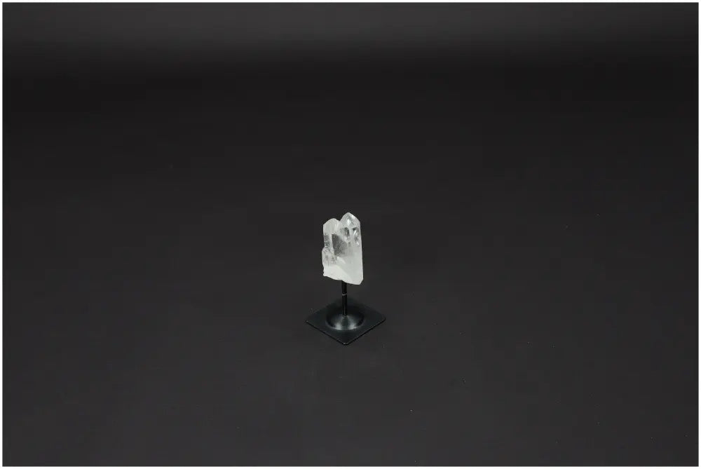 Lemurian Quartz crystal on metal stand against dark background, symbolizing clarity, balance, and personal growth.