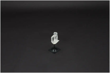 Lemurian Quartz crystal on metal stand against a dark background, exemplifying clarity and balance in crystal healing.