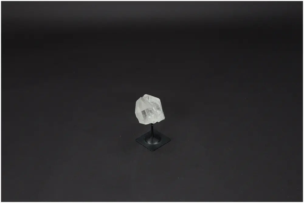 Lemurian Quartz on metal stand against black background, showcasing its clarity and natural beauty, perfect for crystal healing.