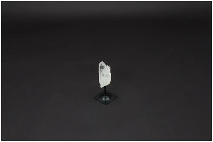 Lemurian Quartz on metal stand against black background, showcasing the crystal's clear structure for clarity and balance.