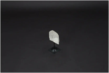 Lemurian Quartz crystal on a metal stand against a dark background, ideal for clarity and emotional balance.
