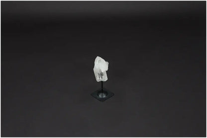 Lemurian Quartz crystal on metal stand against a dark background, showcasing its natural beauty and clarity-enhancing properties.