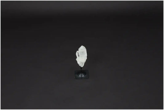Lemurian Quartz crystal on a metal stand, known for enhancing clarity and balance, displayed against a dark background.