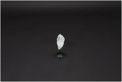 Lemurian Quartz crystal on a metal stand against a dark background, showcasing clarity and healing properties.