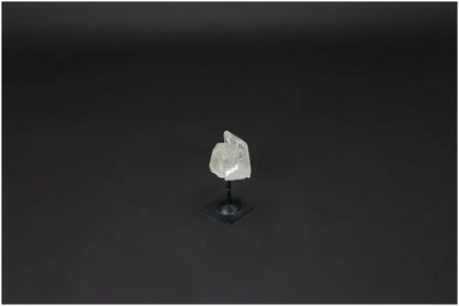 Lemurian Quartz on metal stand, a purifying crystal for balancing energy and neutralizing negative vibrations, displayed on a black background.