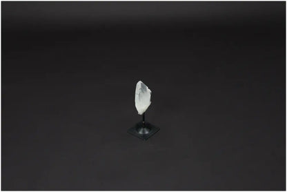 Lemurian Quartz Crystal on black metal stand, known as 'Master Healer' for clarity and balance, used for energy amplification.
