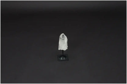 Lemurian Quartz on metal stand with a dark background, ideal for harmonizing body and energy by neutralizing negative vibrations.