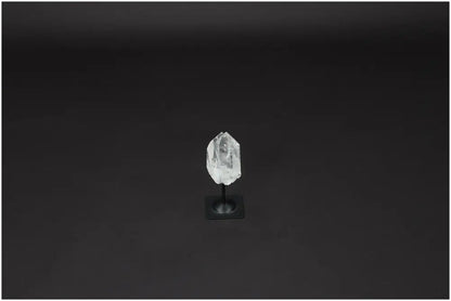 Lemurian Quartz on metal stand, a powerful clear quartz crystal for purification and harmonizing energy, shown against a dark background.