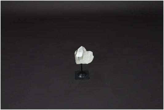 Lemurian quartz crystal on metal stand against dark background, ideal for purification and neutralizing negative energy.
