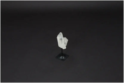 Lemurian Quartz crystal on sleek metal stand, ideal for purification and energy harmonization, against a dark background.