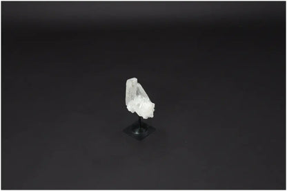Lemurian Quartz on metal stand against dark background, showcasing its clear, purifying properties and harmonizing energy