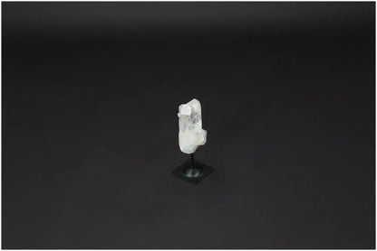 Lemurian Quartz on metal stand against dark background, ideal for purification and energy harmonization.