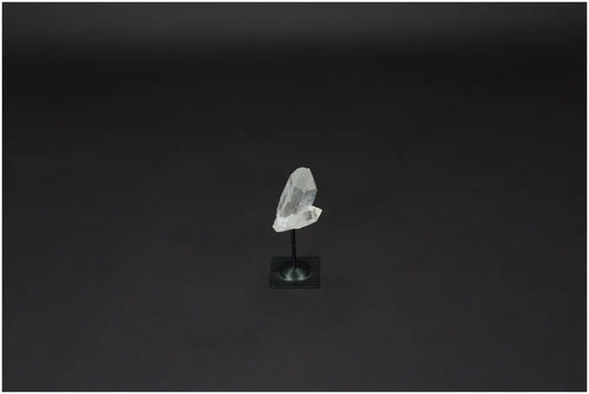 Lemurian Quartz on metal stand, showcasing its clarity and energy purification properties against a plain background.
