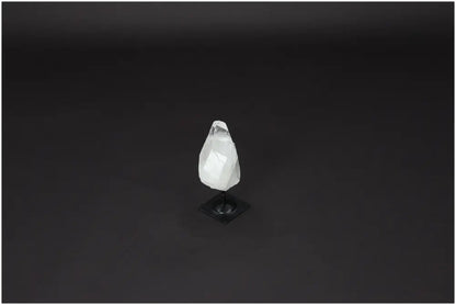 Lemurian Quartz on metal stand, a purification stone for harmonizing energy and neutralizing negative vibrations, against a dark background.