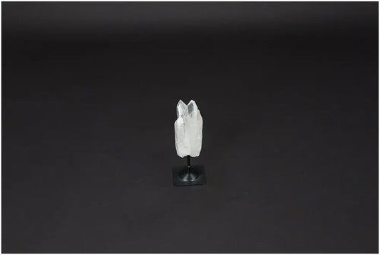 Lemurian Quartz on metal stand, known for purifying energy and neutralizing negativity, ideal for enhancing positive vibrations.