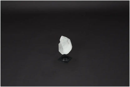 Lemurian Quartz on metal stand for energy purification and harmonization on dark background.