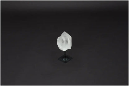 Lemurian Quartz on metal stand against dark background, showcasing its clear crystal structure and purification properties.
