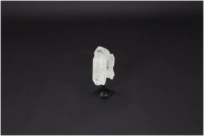 Lemurian Quartz on Metal Stand, known for energy purification and harmonizing benefits, against a dark background.