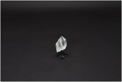 Lemurian Quartz on metal stand against dark background, ideal for purification, harmonizing energy, and neutralizing negative vibrations.