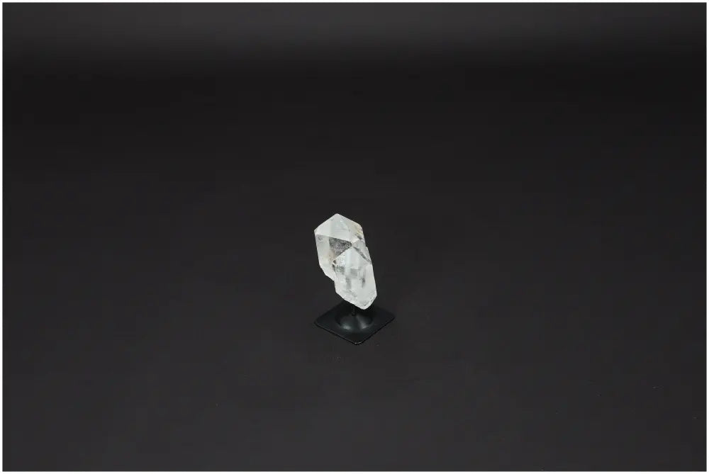 Lemurian Quartz crystal on a metal stand, known for its purifying properties, ideal for harmonizing body, mind, and energy spaces.
